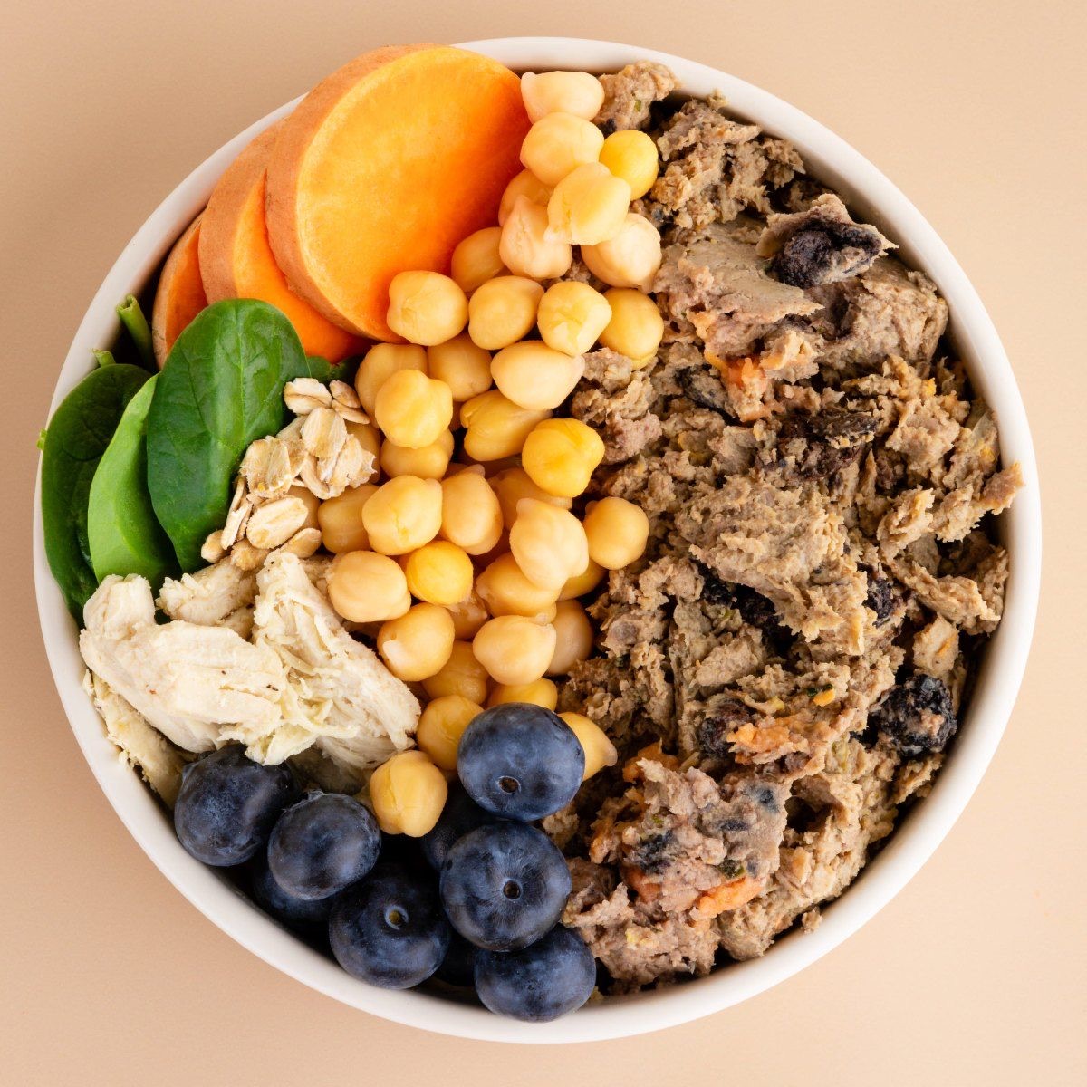 A bowl of DASH Chicken Recipe with sweet potato, spinach, chickpeas and blueberries
